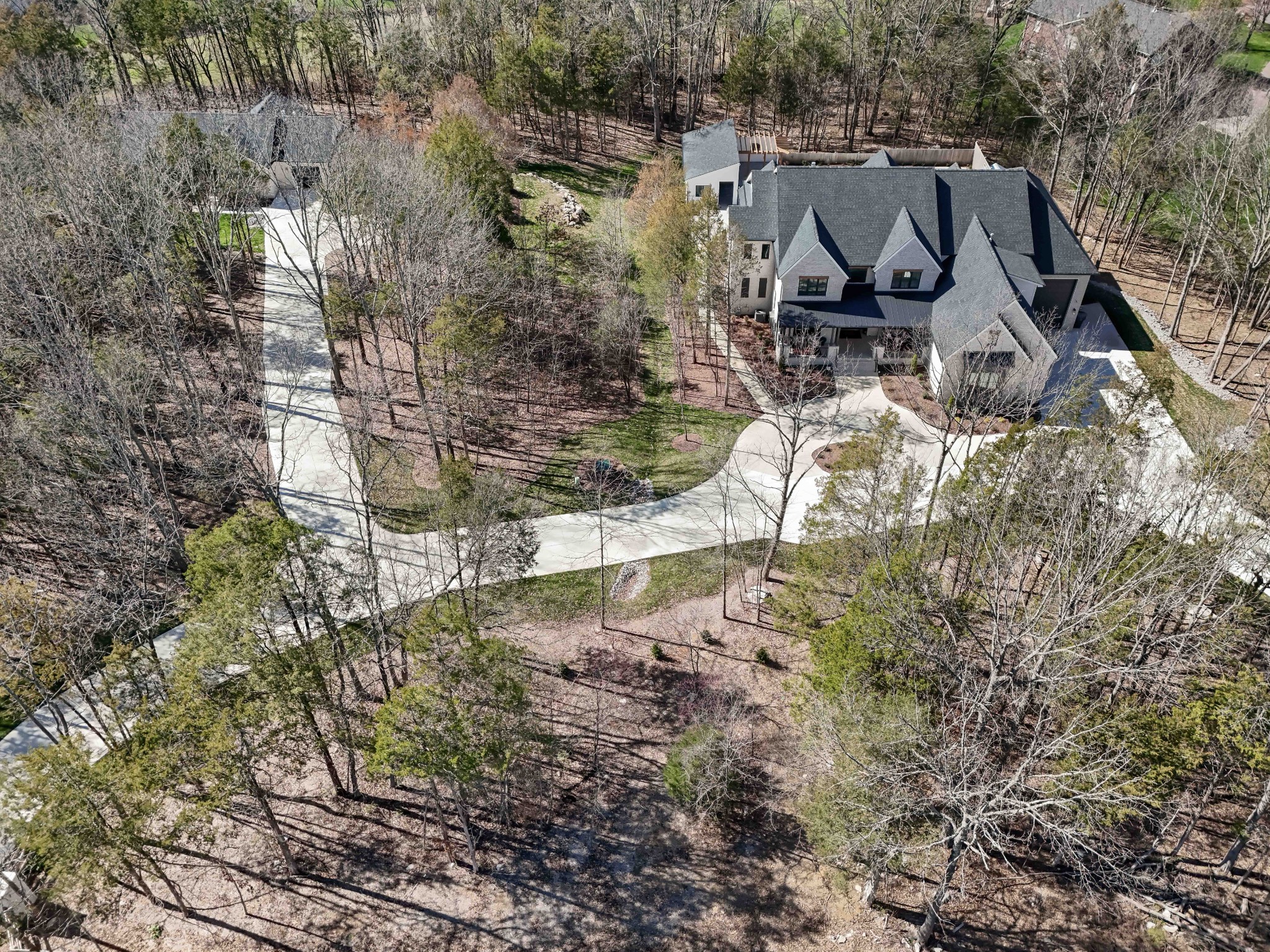 a aerial view of a house with yard and lake view