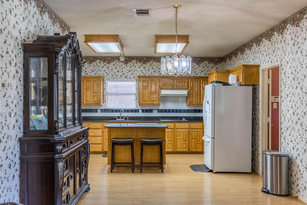 4113 Bluffpoint Road Rowlett, TX 75088 - Photo 12 of 39 a kitchen with stainless steel appliances granite countertop a refrigerator a stove and a sink