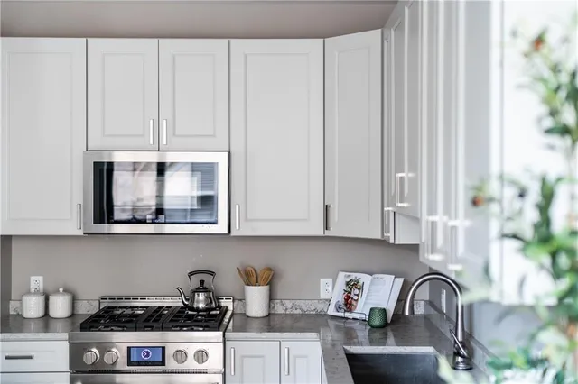 a open kitchen with stainless steel appliances granite countertop a lot of counter space and wooden floor