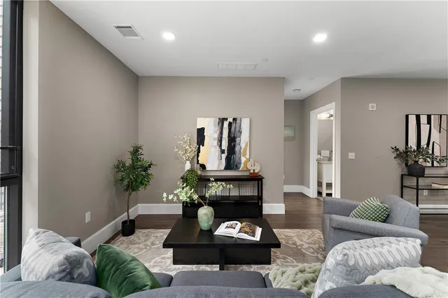 a living room with furniture and wooden floor