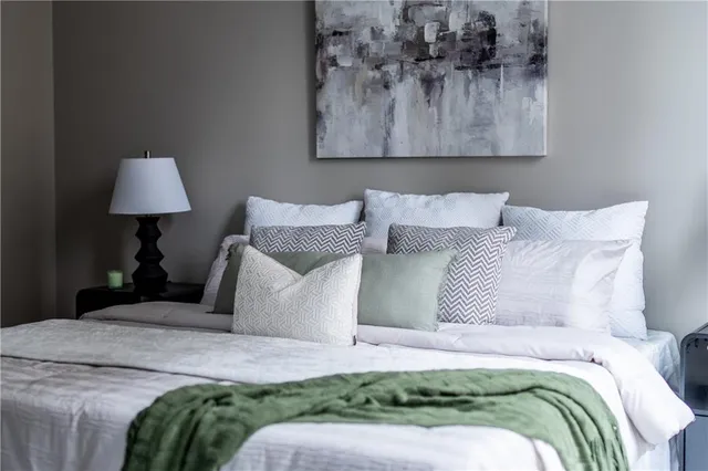 a bedroom with a bed and a painting