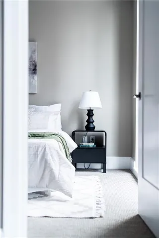 a bathroom with a granite countertop sink a toilet and shower