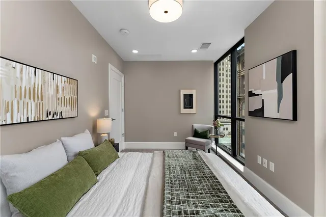 a bedroom with a large bed and a chandelier