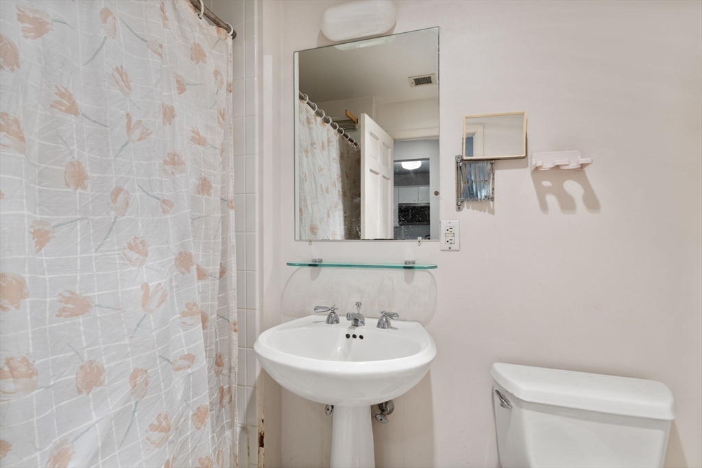 197 8th Street, Unit 728 Boston, MA 02129 - Photo 13 of 29 a bathroom with a sink a mirror and a toilet