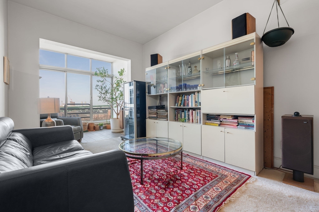 197 8th Street, Unit 728 Boston, MA 02129 - Photo 2 of 29 a living room with furniture and a rug