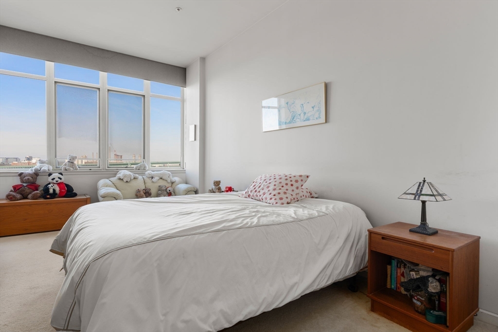 197 8th Street, Unit 728 Boston, MA 02129 - Photo 8 of 29 a bedroom with bed and a chandelier