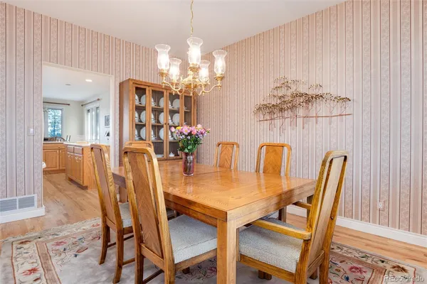 a view of a dining room with furniture and chandelier