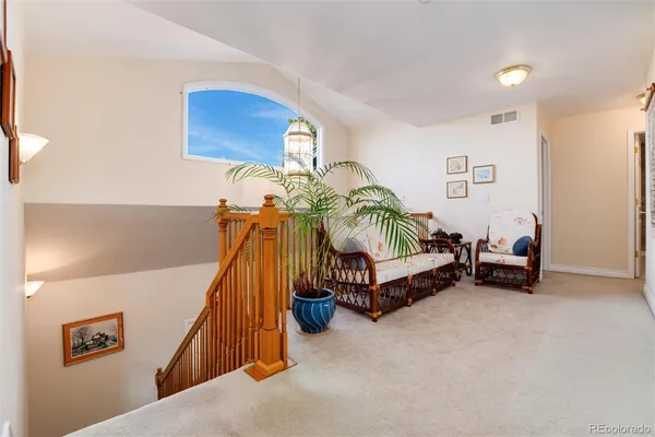 a bedroom with furniture and a lamp