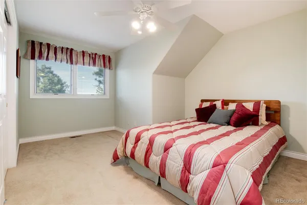a bedroom with bed and a book shelf