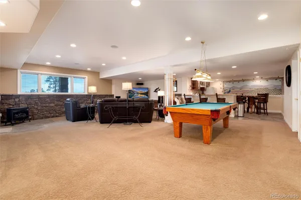 a living room with furniture and a dining table with kitchen view