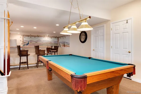 a room with furniture and pool table