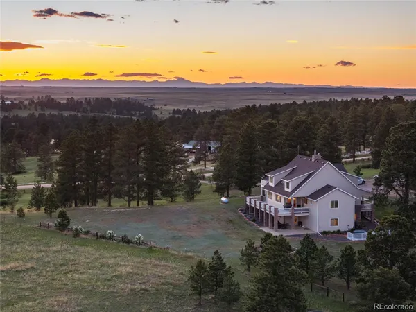 an aerial view of a house with a yard and lake view