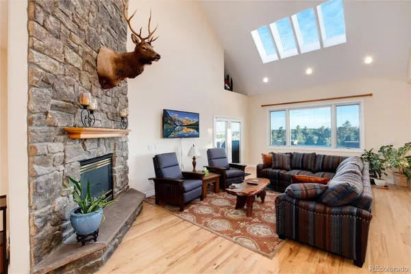 a living room with furniture large window and fireplace