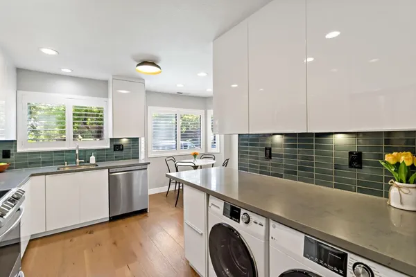 a kitchen with stainless steel appliances granite countertop a sink and a stove