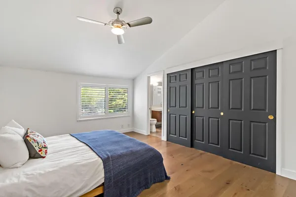 a bedroom with a large bed and a chandelier