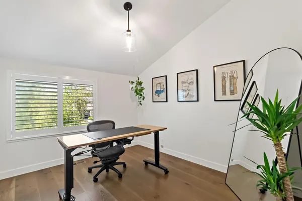 a workspace with furniture and a potted plant