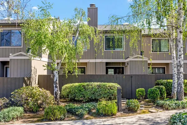 a front view of a house with a yard and outdoor seating