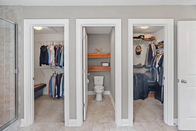 a view of a walk in closet and a bathroom