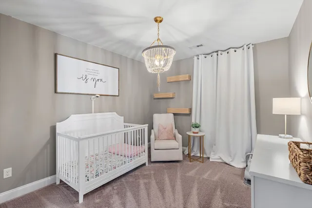 a bed room with a bed and a chair