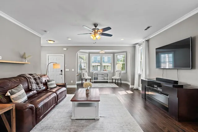 a living room with furniture fireplace and a flat screen tv