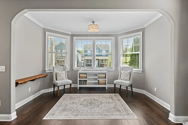 a living room with furniture a rug and a table