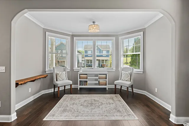 a living room with furniture a rug and a table