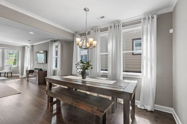 a view of a dining room with furniture window and wooden floor