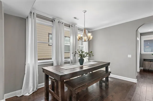 a view of a dining room with a table and chairs