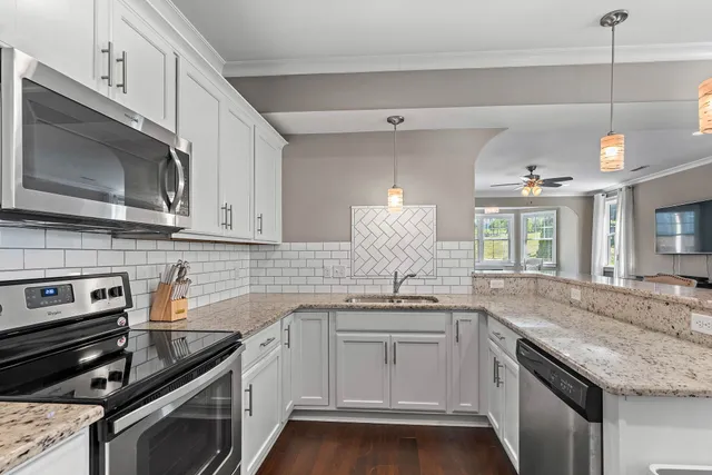a kitchen with a sink stove and microwave
