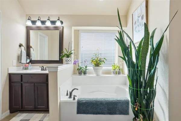 a bathroom with a sink a mirror and a shower