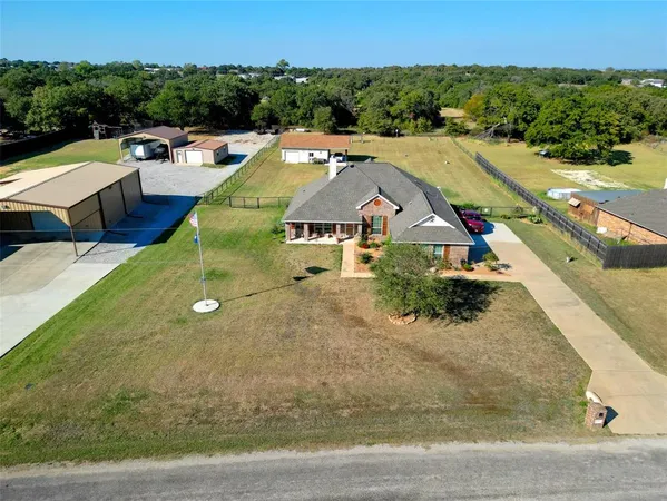 a view of a house with a yard and sitting area