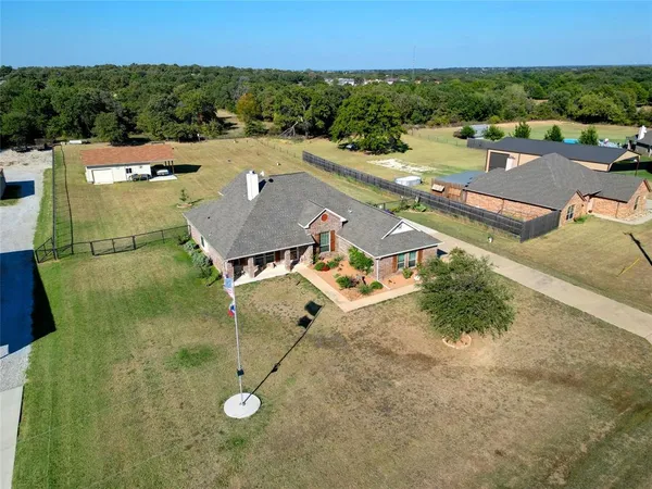 an aerial view of a house with a yard