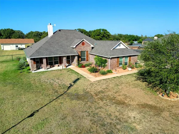 an aerial view of a house with outdoor space