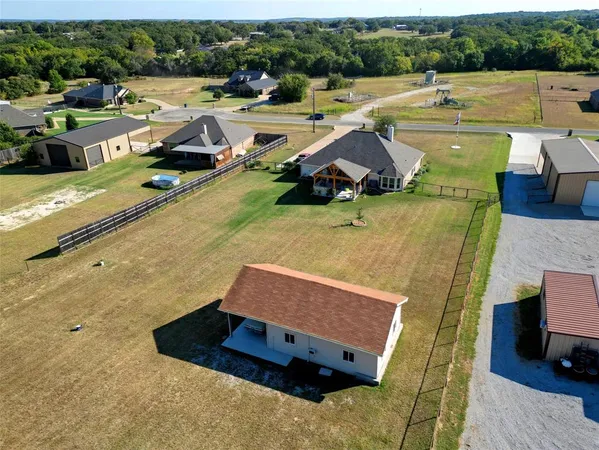 an aerial view of a house with outdoor space