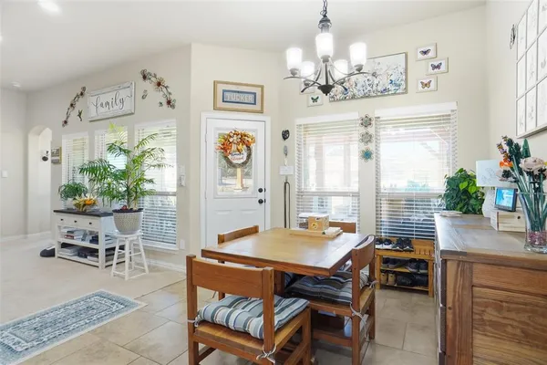 a dining room filled with furniture and window