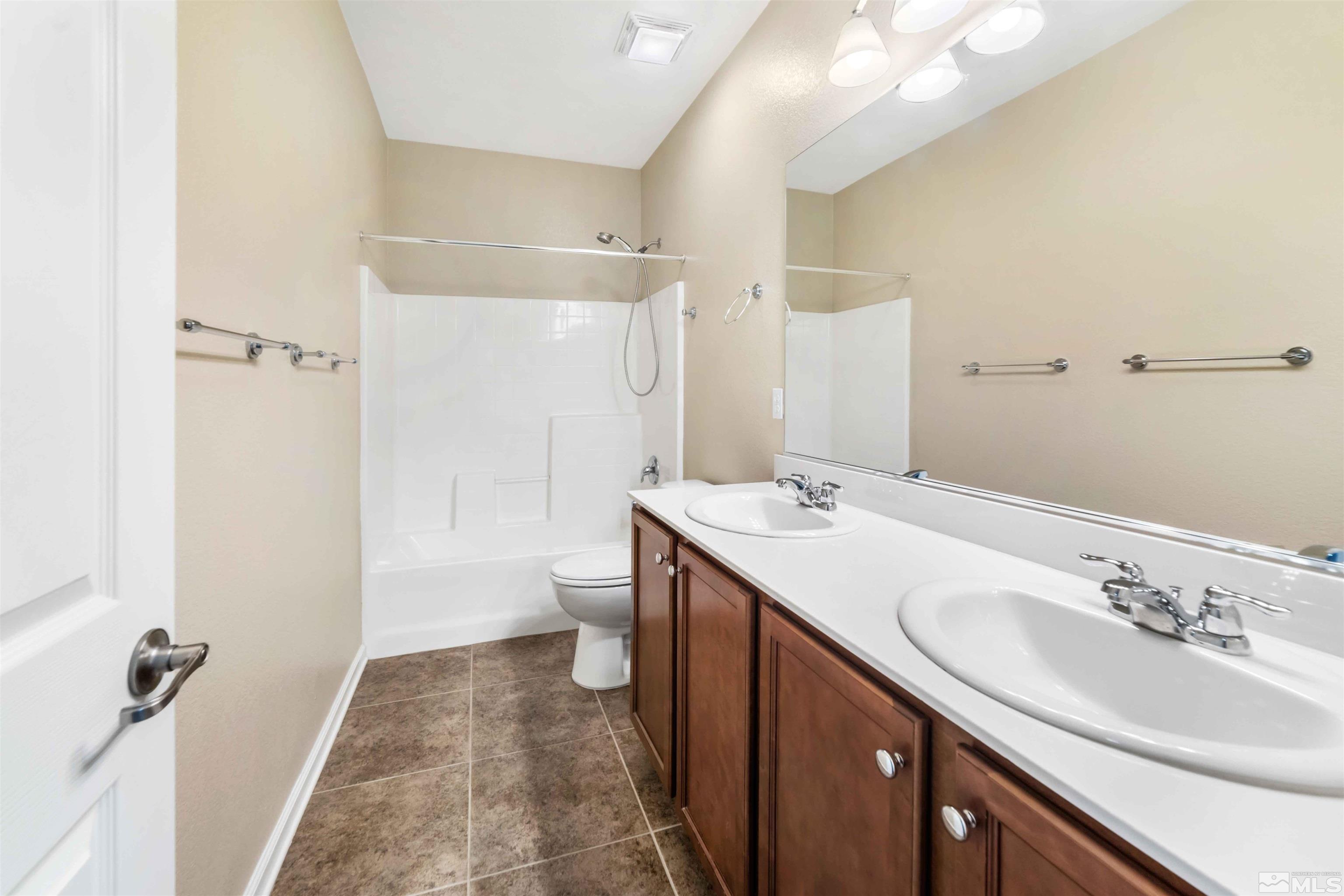 10790 Cedar Rock Drive Reno, NV 89521 - Photo 16 of 34 a bathroom with a sink a toilet and shower