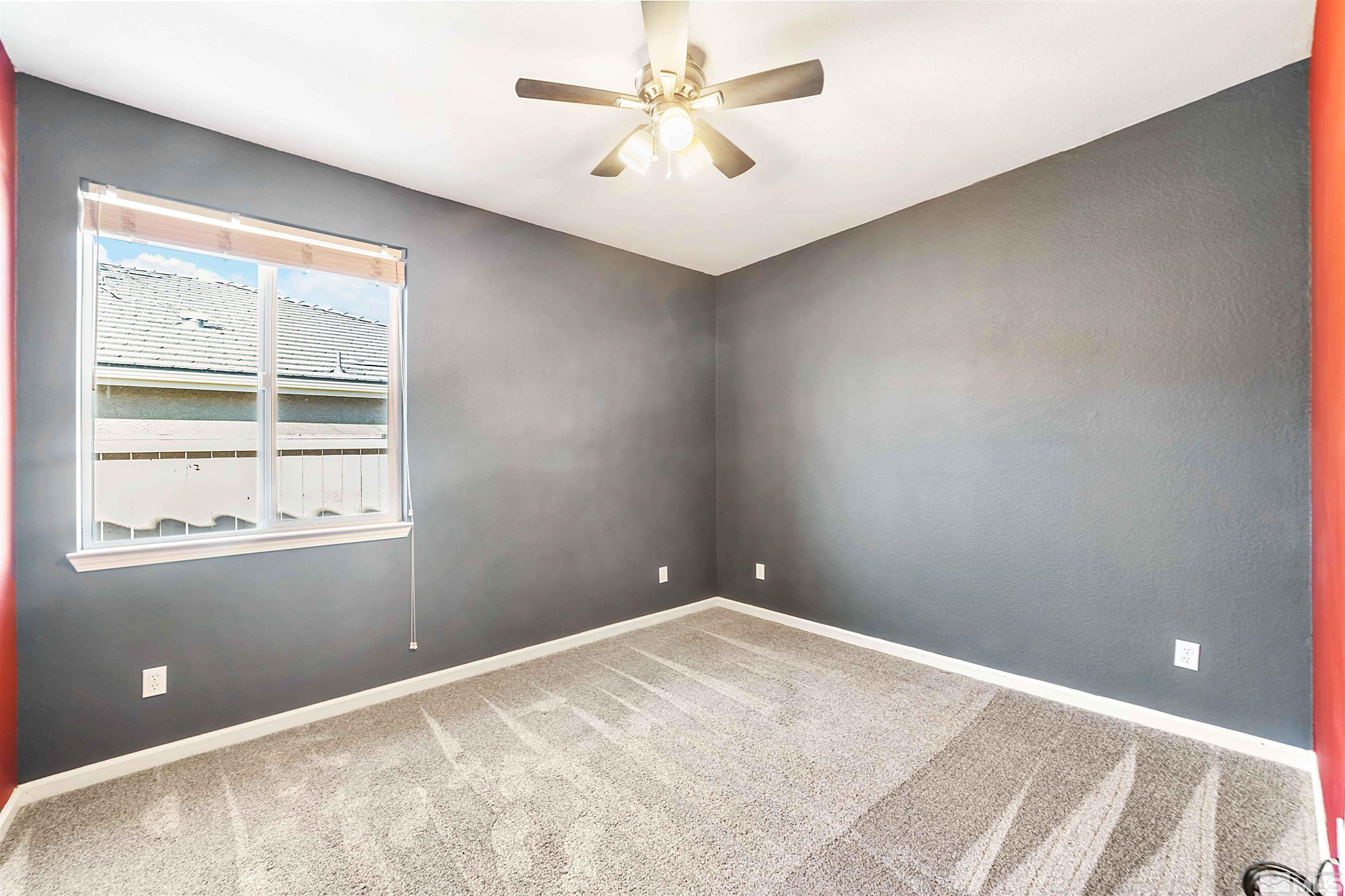 10790 Cedar Rock Drive Reno, NV 89521 - Photo 18 of 34 a view of a room with a ceiling fan and carpet