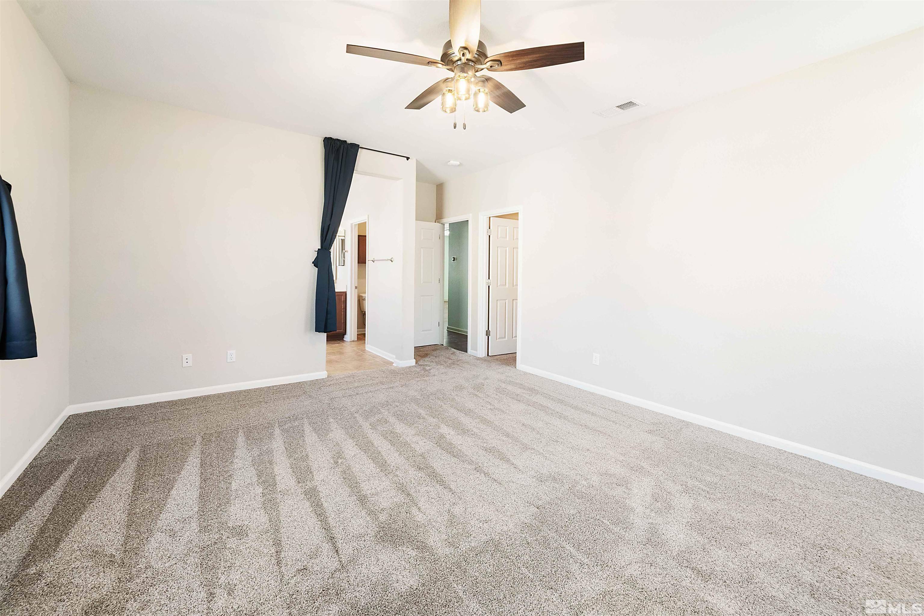 10790 Cedar Rock Drive Reno, NV 89521 - Photo 21 of 34 an empty room with a ceiling fan and a window