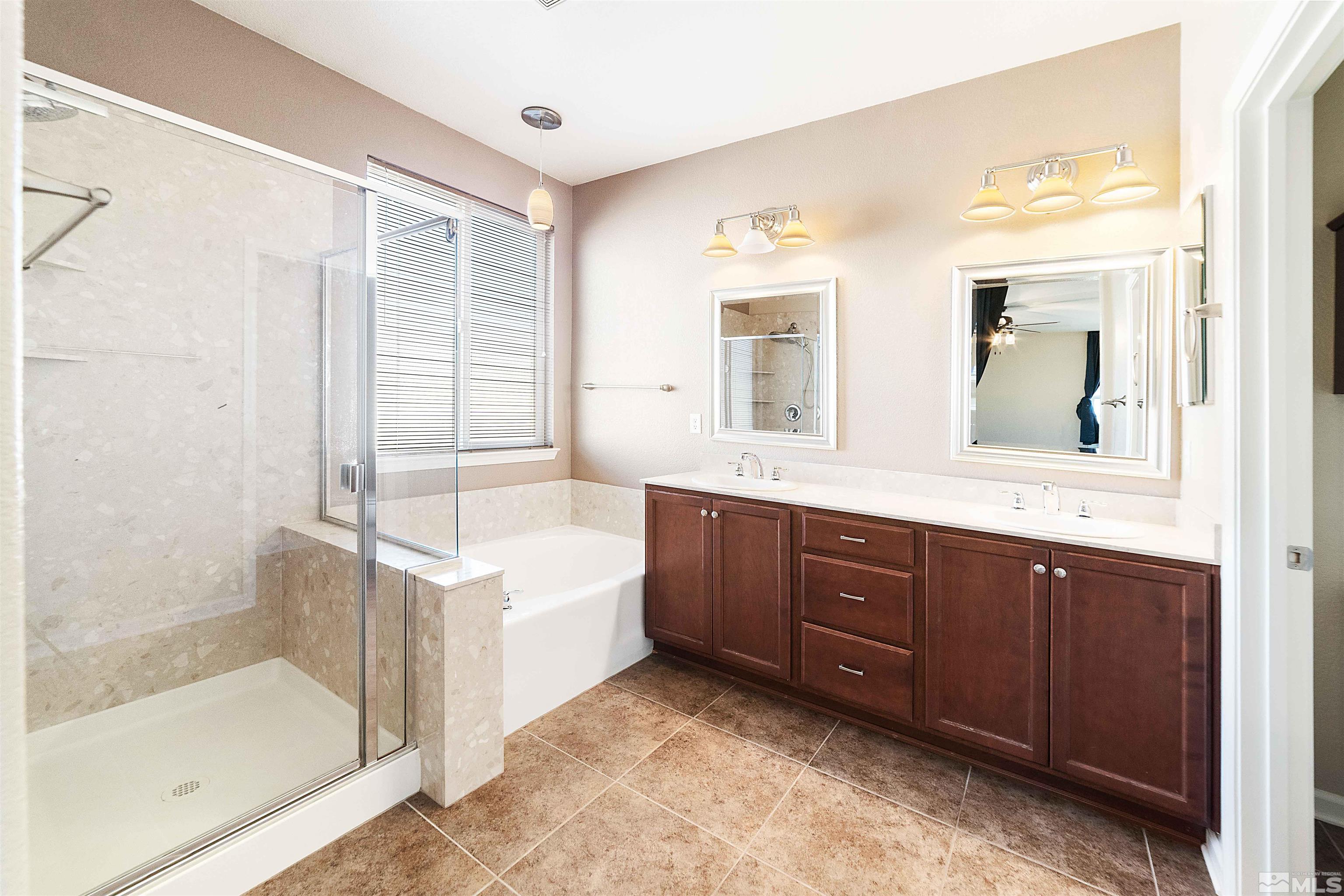 10790 Cedar Rock Drive Reno, NV 89521 - Photo 23 of 34 a spacious bathroom with a tub sink shower and mirror