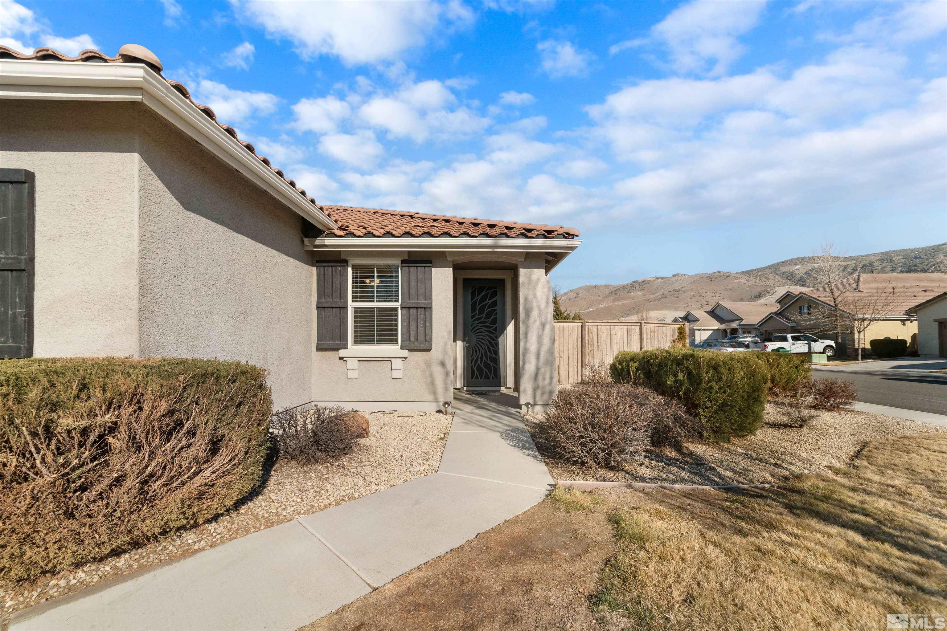 10790 Cedar Rock Drive Reno, NV 89521 - Photo 4 of 34 a front view of a house with a yard