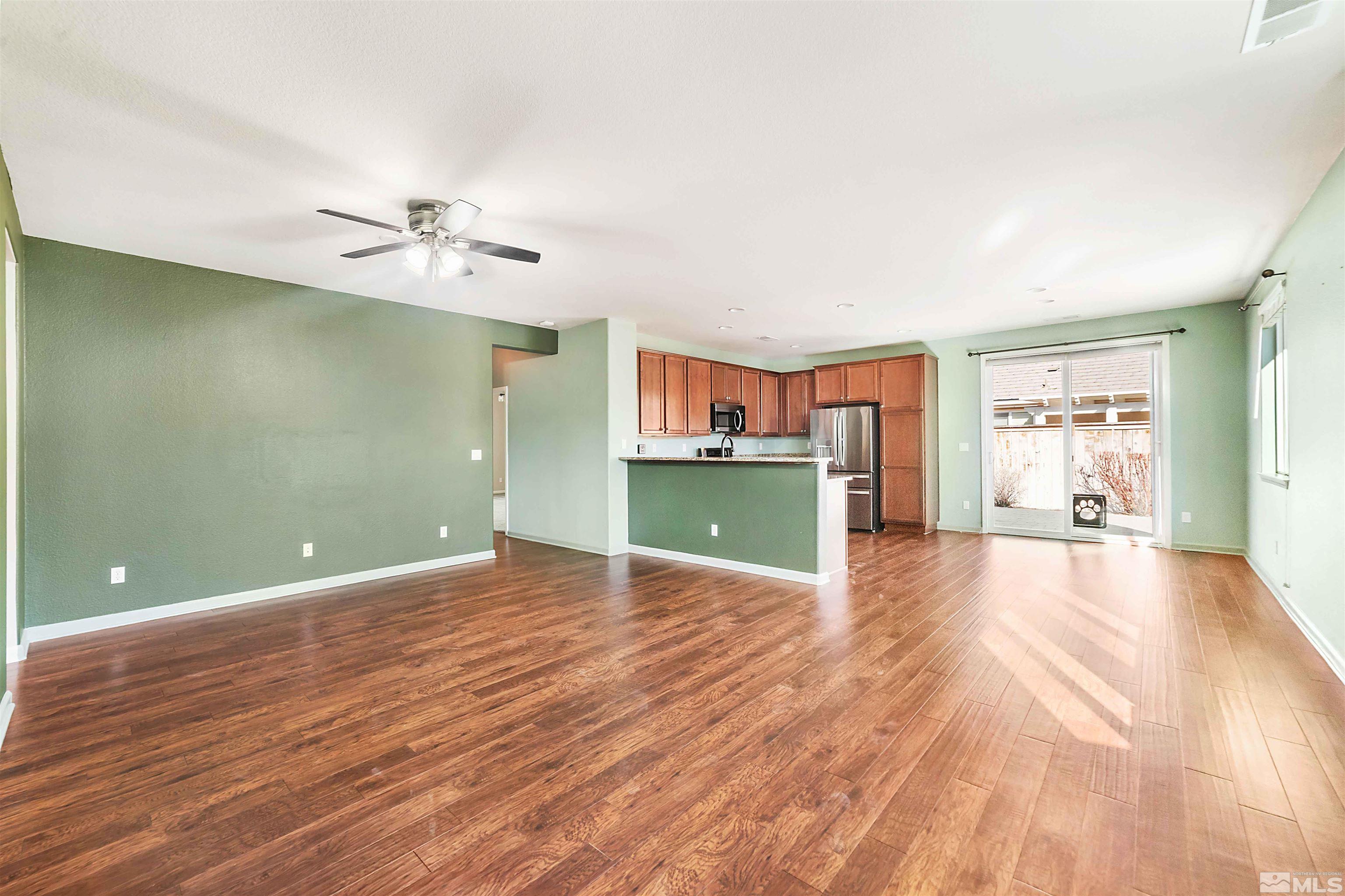 10790 Cedar Rock Drive Reno, NV 89521 - Photo 6 of 34 a view of a room with a wooden floor and a kitchen