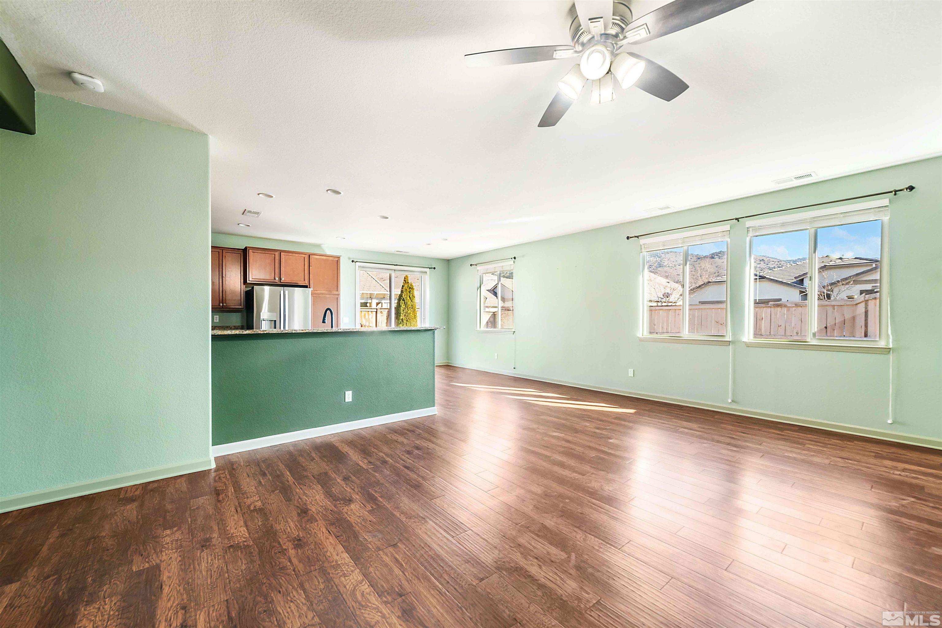 10790 Cedar Rock Drive Reno, NV 89521 - Photo 7 of 34 a view of an empty room with window and wooden floor