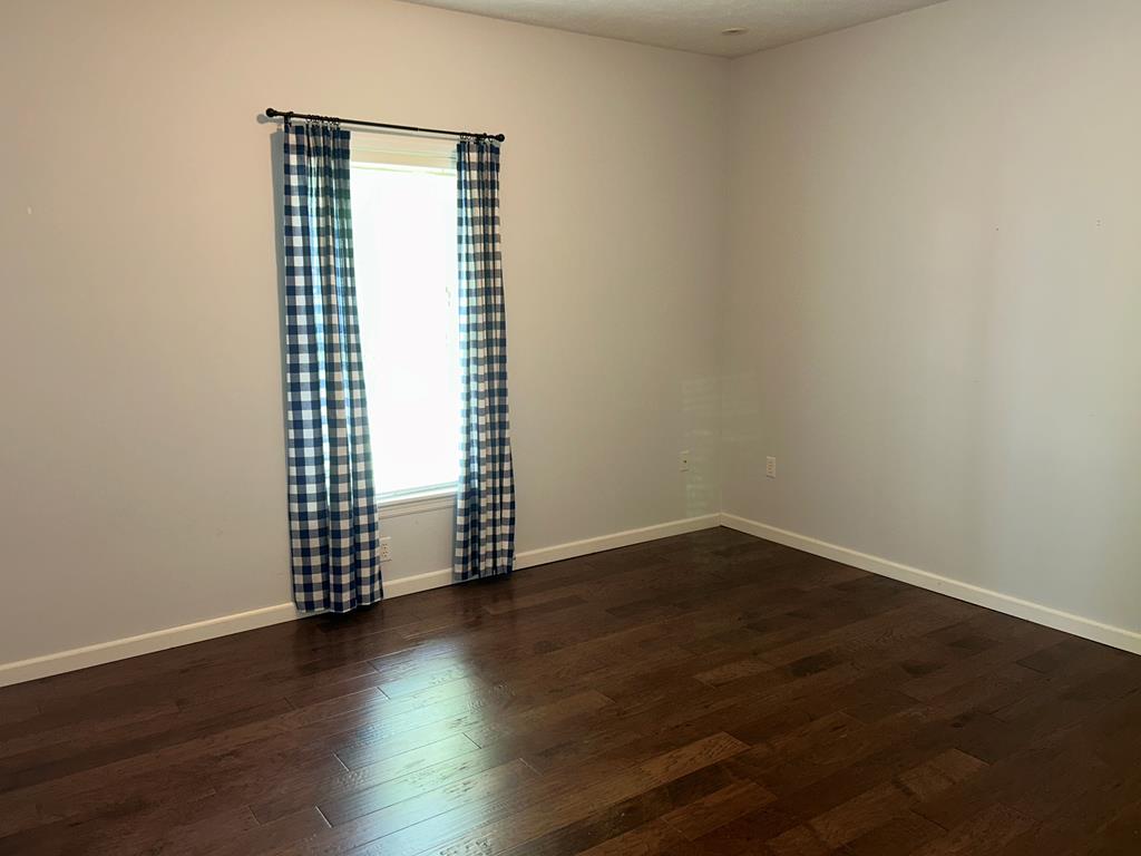 114 Oak Ridge Drive Clarion, PA 16214 - Photo 31 of 38 an empty room with wooden floor and windows