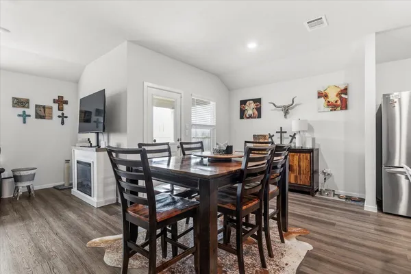 a view of a dining room with furniture and wooden floor