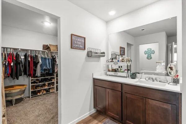 a bathroom with a double vanity sink and a mirror
