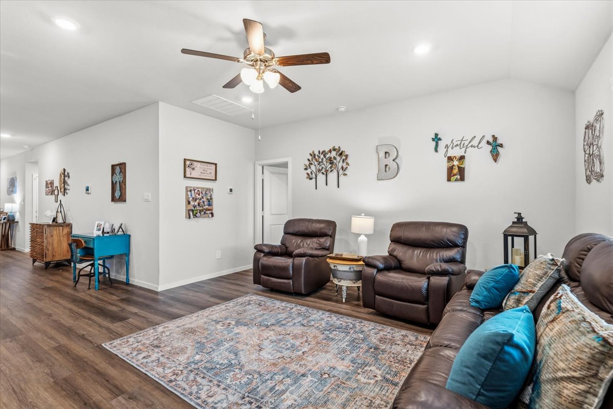 402 Perry Place Rockdale, TX 76567 - Photo 20 of 31 Living area featuring a ceiling fan, dark wood-type flooring, recessed lighting, and vaulted ceiling