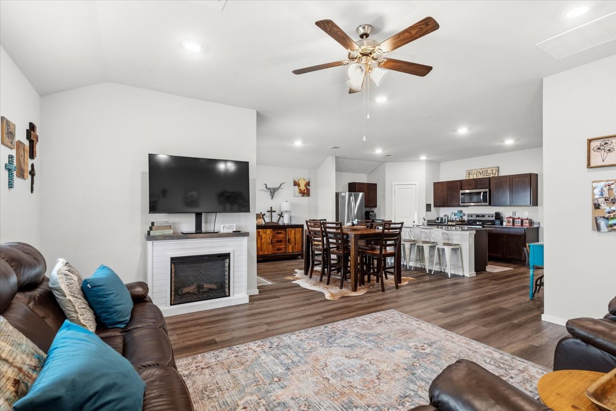 402 Perry Place Rockdale, TX 76567 - Photo 21 of 31 Living area featuring a ceiling fan, dark wood-style floors, a fireplace, recessed lighting, and lofted ceiling
