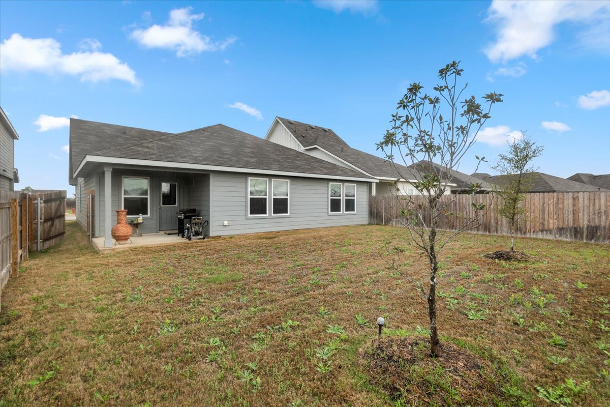 402 Perry Place Rockdale, TX 76567 - Photo 28 of 31 Rear view of house with a patio and a fenced backyard