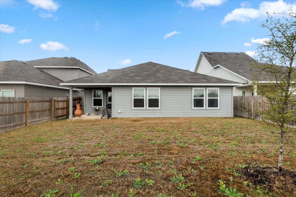 402 Perry Place Rockdale, TX 76567 - Photo 29 of 31 Rear view of house featuring a patio area, a fenced backyard, and a shingled roof