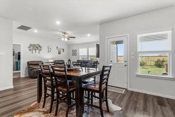 a view of a dining room with furniture and wooden floor
